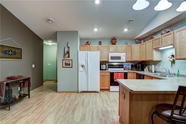 13037 40th Ave Ave, Chippewa Falls, WI 54729 - kitchen with white appliances, light countertops, light brown cabinetry, light wood finished floors, and a sink