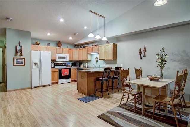13037 40th Ave Ave, Chippewa Falls, WI 54729 - kitchen with white appliances, a peninsula, light wood-style flooring, a sink, and light brown cabinets