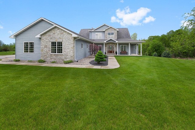 W5412 Bowe Ln, Fond Du Lac, WI 54937 - view of front of property with stone siding, a front lawn, and covered porch