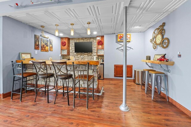W5412 Bowe Ln, Fond Du Lac, WI 54937 - indoor bar with an ornate ceiling, baseboards, wood finished floors, and hanging light fixtures