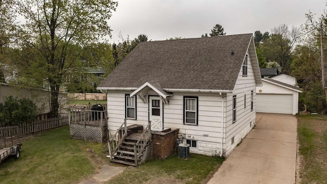 207 E Sumner St, Weyauwega, WI 54983 - view of front of home with roof with shingles, a garage, cooling unit, and a wooden deck