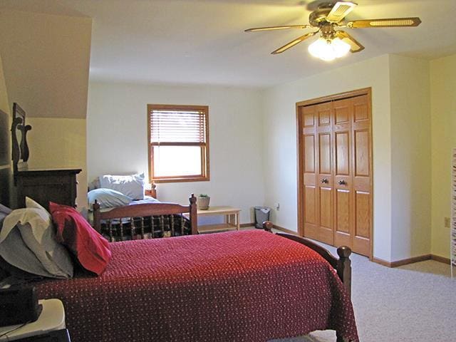 1060 Kamla Ct, Platteville, WI 53818 - carpeted bedroom with ceiling fan, baseboards, and a closet