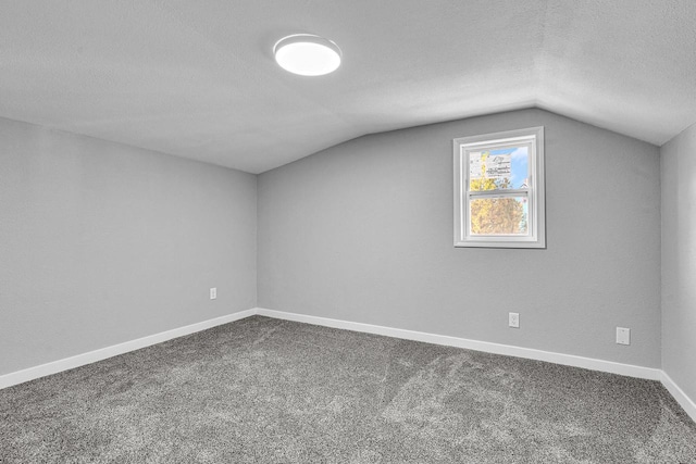 1629 Kentucky Ave, Sheboygan, WI 53081 - bonus room with lofted ceiling, a textured ceiling, dark colored carpet, and baseboards