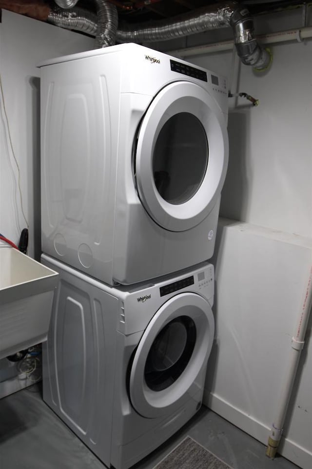 clothes washing area featuring estacked washer and dryer
