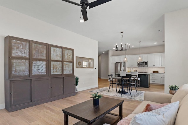 1801 Opus Ln Unit 101, Verona, WI 53593 - living area featuring a chandelier, ceiling fan, light wood finished floors, baseboards, and recessed lighting