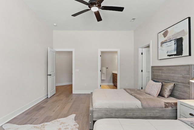 1801 Opus Ln Unit 101, Verona, WI 53593 - bedroom with light wood-type flooring, baseboards, ensuite bathroom, and ceiling fan