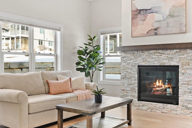 1801 Opus Ln Unit 101, Verona, WI 53593 - living area with wood finished floors, a stone fireplace, and a towering ceiling