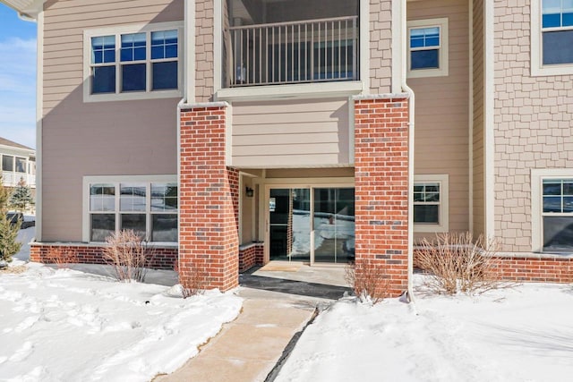 1801 Opus Ln Unit 101, Verona, WI 53593 - snow covered property entrance with brick siding