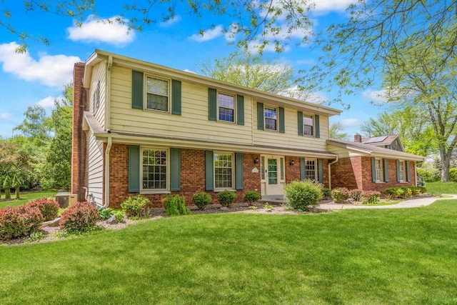 2845 Cambridge Cir, Brookfield, WI 53045 - view of front facade featuring a chimney, brick siding, a front yard, and cooling unit