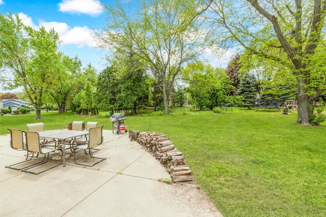 2845 Cambridge Cir, Brookfield, WI 53045 - view of patio / terrace with outdoor dining space, grilling area, a trampoline, and view of wooded area