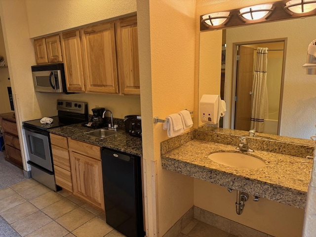 2504 River Rd Unit 7105, Wisconsin Dells, WI 53965 - kitchen with appliances with stainless steel finishes, a sink, a textured wall, light tile patterned floors, and dark stone countertops