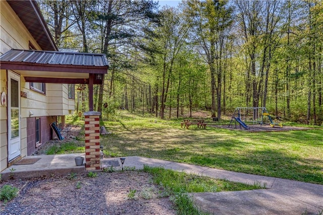 10148 Mcclaine Rd, Hayward, WI 54843 - view of grassy yard featuring a playground and a forest view