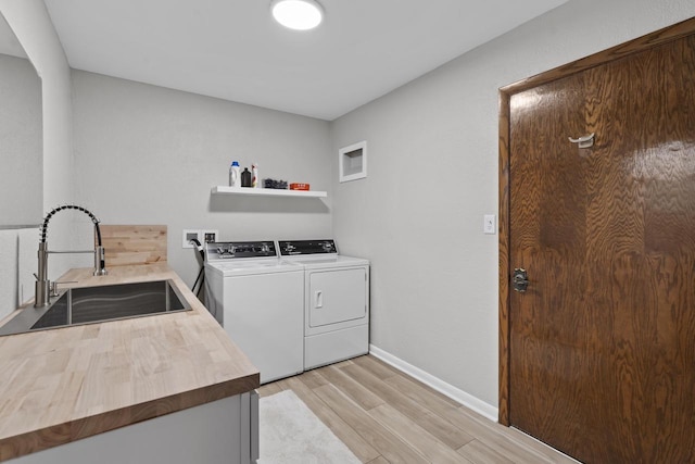 S58W22640 Glengarry Rd, Waukesha, WI 53189 - washroom featuring washing machine and clothes dryer, light wood finished floors, and baseboards