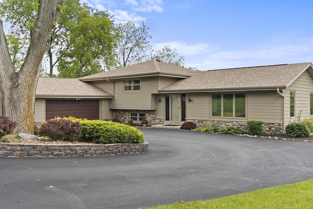 S58W22640 Glengarry Rd, Waukesha, WI 53189 - split level home with a garage, roof with shingles, driveway, and stone siding
