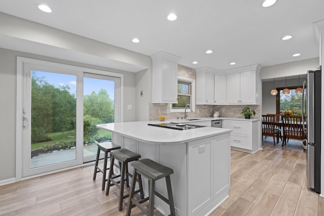 S58W22640 Glengarry Rd, Waukesha, WI 53189 - kitchen featuring stainless steel appliances, a sink, white cabinets, light countertops, and recessed lighting