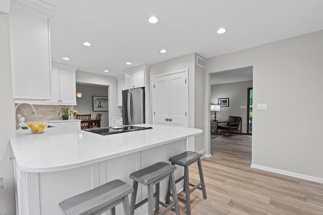 S58W22640 Glengarry Rd, Waukesha, WI 53189 - kitchen with freestanding refrigerator, a peninsula, a sink, baseboards, and decorative backsplash