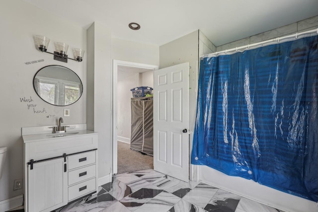 bathroom featuring vanity and marble finish flooring