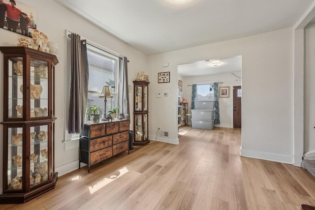 foyer with wood finished floors and baseboards
