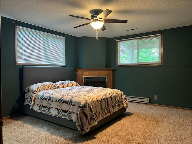 1123 Glades Dr, Altoona, WI 54720 - bedroom featuring a baseboard heating unit, carpet, a ceiling fan, baseboards, and a textured ceiling