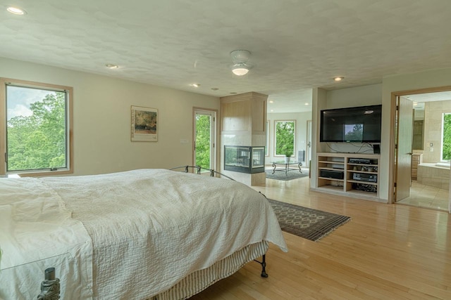 W6504 Klassy Rd, New Glarus, WI 53574 - bedroom featuring light wood-style floors, recessed lighting, and ensuite bath