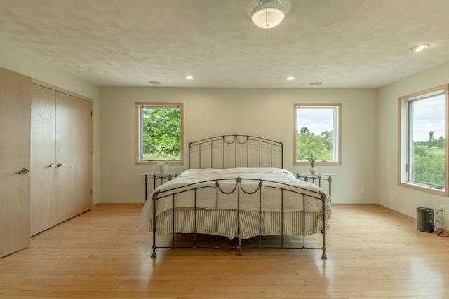 W6504 Klassy Rd, New Glarus, WI 53574 - bedroom featuring multiple windows, light wood-type flooring, baseboards, and recessed lighting