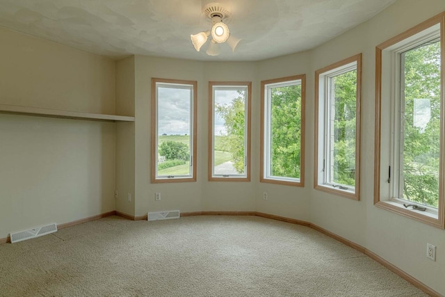 W6504 Klassy Rd, New Glarus, WI 53574 - unfurnished room featuring healthy amount of natural light, carpet floors, a ceiling fan, and baseboards