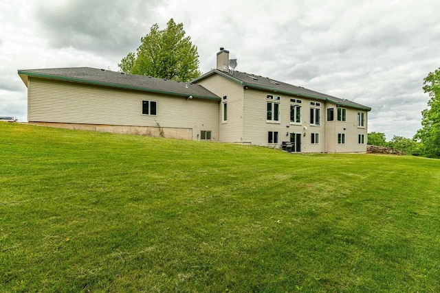 W6504 Klassy Rd, New Glarus, WI 53574 - rear view of property with a lawn and a chimney