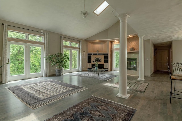W6504 Klassy Rd, New Glarus, WI 53574 - living room with ornate columns, wood finished floors, lofted ceiling, and a tiled fireplace