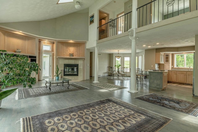 W6504 Klassy Rd, New Glarus, WI 53574 - living room with high vaulted ceiling, plenty of natural light, wood finished floors, and a tiled fireplace