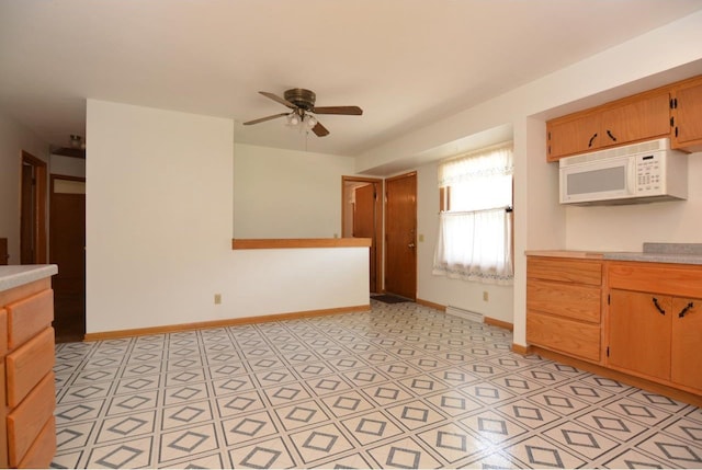 4802 Meredithe Ave, Madison, WI 53716 - kitchen featuring white microwave, a ceiling fan, light countertops, and baseboards