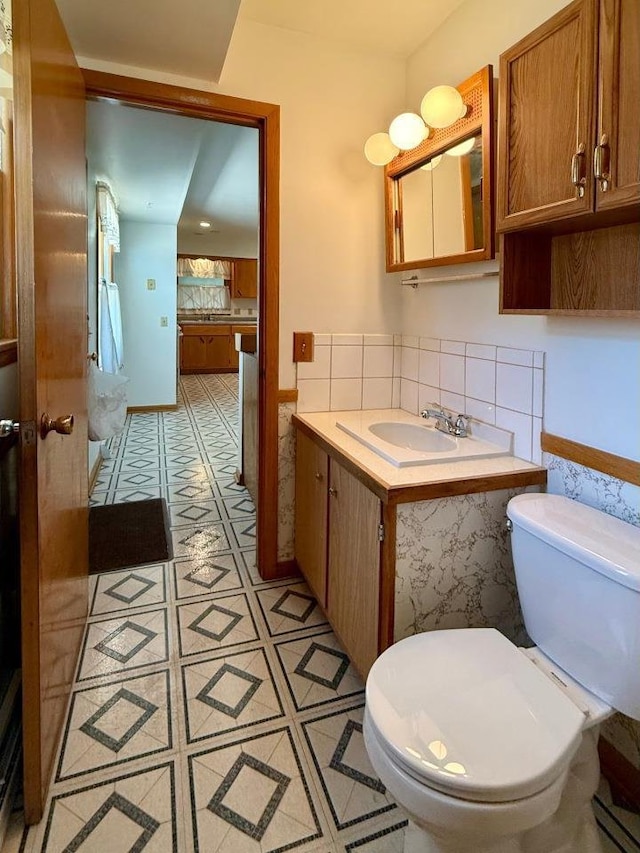 4802 Meredithe Ave, Madison, WI 53716 - half bath with toilet, tile walls, vanity, and a wainscoted wall