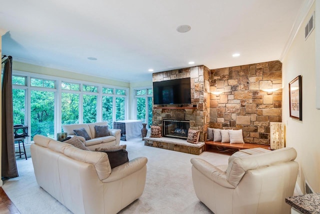 9121 Blackhawk Rd, Middleton, WI 53562 - living area with crown molding, a stone fireplace, and recessed lighting