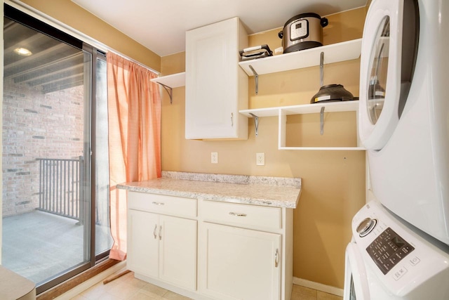 8735 N 72nd St Unit 202, Milwaukee, WI 53223 - washroom with stacked washer / dryer and cabinet space