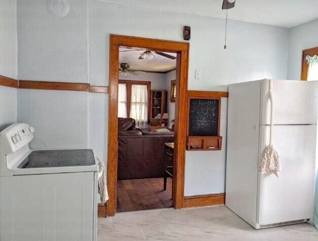 kitchen featuring white appliances and a ceiling fan