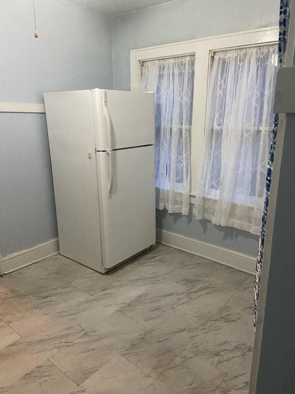 4715 N 39th St, Milwaukee, WI 53209 - kitchen with freestanding refrigerator and baseboards