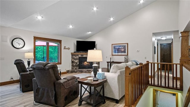 E3313 Jennifer Ln, Eau Claire, WI 54701 - living area featuring light wood-type flooring, baseboards, a brick fireplace, high vaulted ceiling, and recessed lighting
