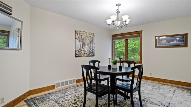 E3313 Jennifer Ln, Eau Claire, WI 54701 - dining space with a chandelier, baseboards, and wood finished floors