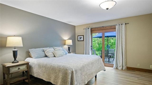 E3313 Jennifer Ln, Eau Claire, WI 54701 - bedroom featuring wood finished floors, access to exterior, and baseboards