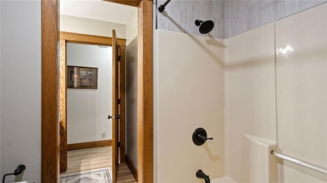 E3313 Jennifer Ln, Eau Claire, WI 54701 - bathroom with shower / bathtub combination, wood finished floors, and baseboards