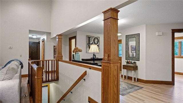 E3313 Jennifer Ln, Eau Claire, WI 54701 - stairway with decorative columns, wood finished floors, and baseboards