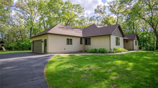 E3313 Jennifer Ln, Eau Claire, WI 54701 - ranch-style house with a garage, a front yard, and driveway