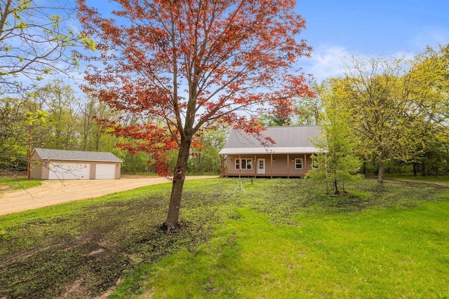 2806 3rd Ct, Oxford, WI 53952 - view of front facade with an outbuilding, driveway, a detached garage, and a front yard