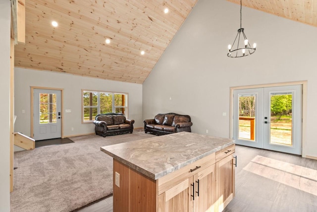 2806 3rd Ct, Oxford, WI 53952 - kitchen with high vaulted ceiling, a chandelier, open floor plan, light brown cabinets, and a center island
