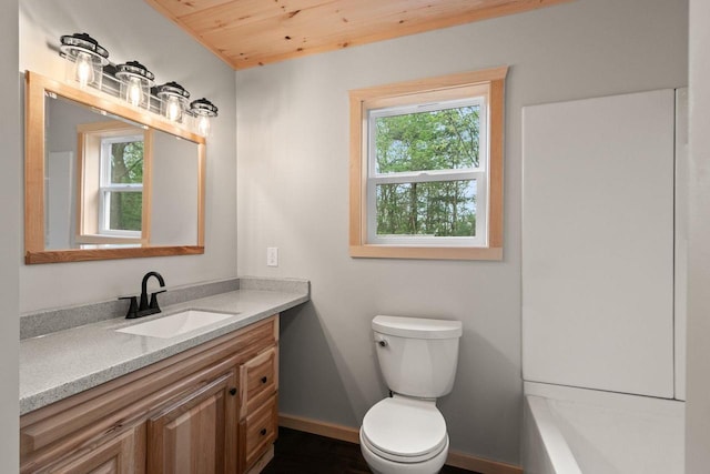 2806 3rd Ct, Oxford, WI 53952 - full bathroom with wood ceiling, toilet, vanity, and baseboards