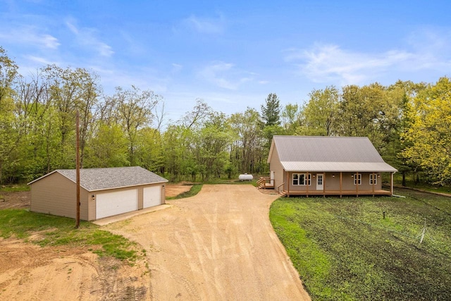 2806 3rd Ct, Oxford, WI 53952 - view of front of property with an outdoor structure, a detached garage, driveway, metal roof, and a porch