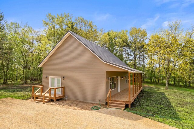 2806 3rd Ct, Oxford, WI 53952 - view of property exterior featuring french doors, a lawn, and a deck