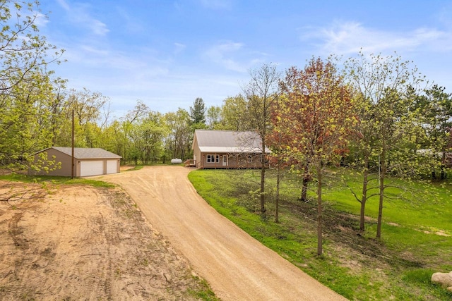 2806 3rd Ct, Oxford, WI 53952 - view of front of home with dirt driveway, an outdoor structure, and a detached garage