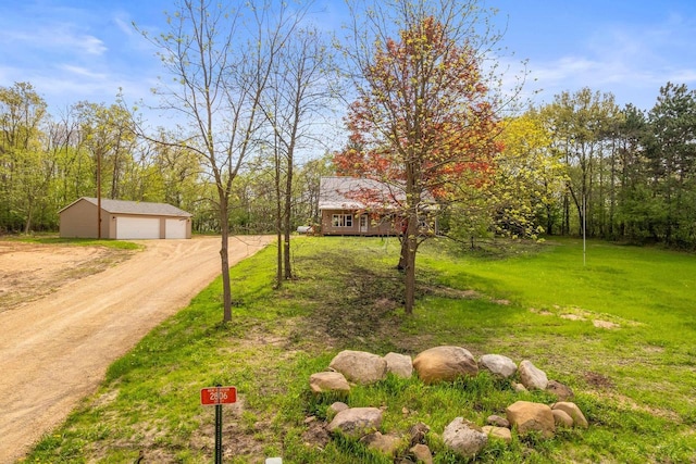 2806 3rd Ct, Oxford, WI 53952 - view of grassy yard featuring an outdoor structure, a garage, and dirt driveway