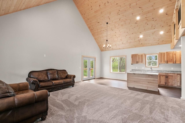 2806 3rd Ct, Oxford, WI 53952 - living room with dark colored carpet, high vaulted ceiling, wood ceiling, baseboards, and a chandelier