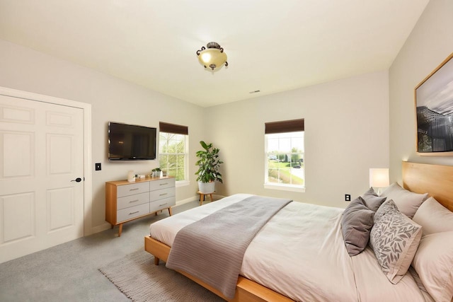 bedroom featuring light colored carpet